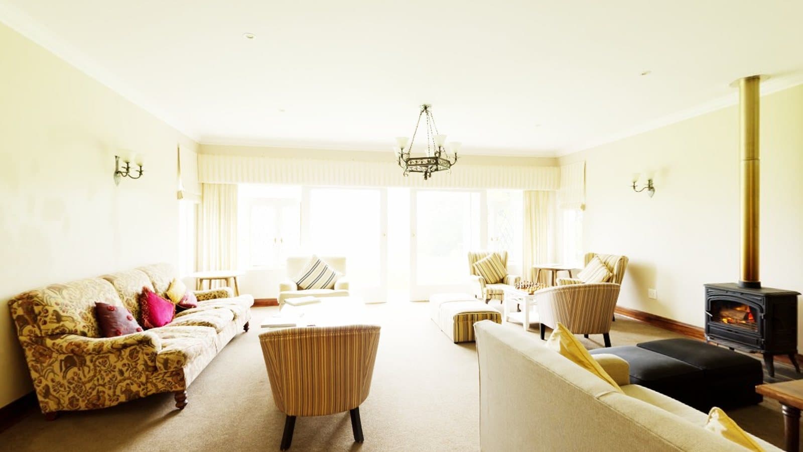 A bright living room with sofas and large windows