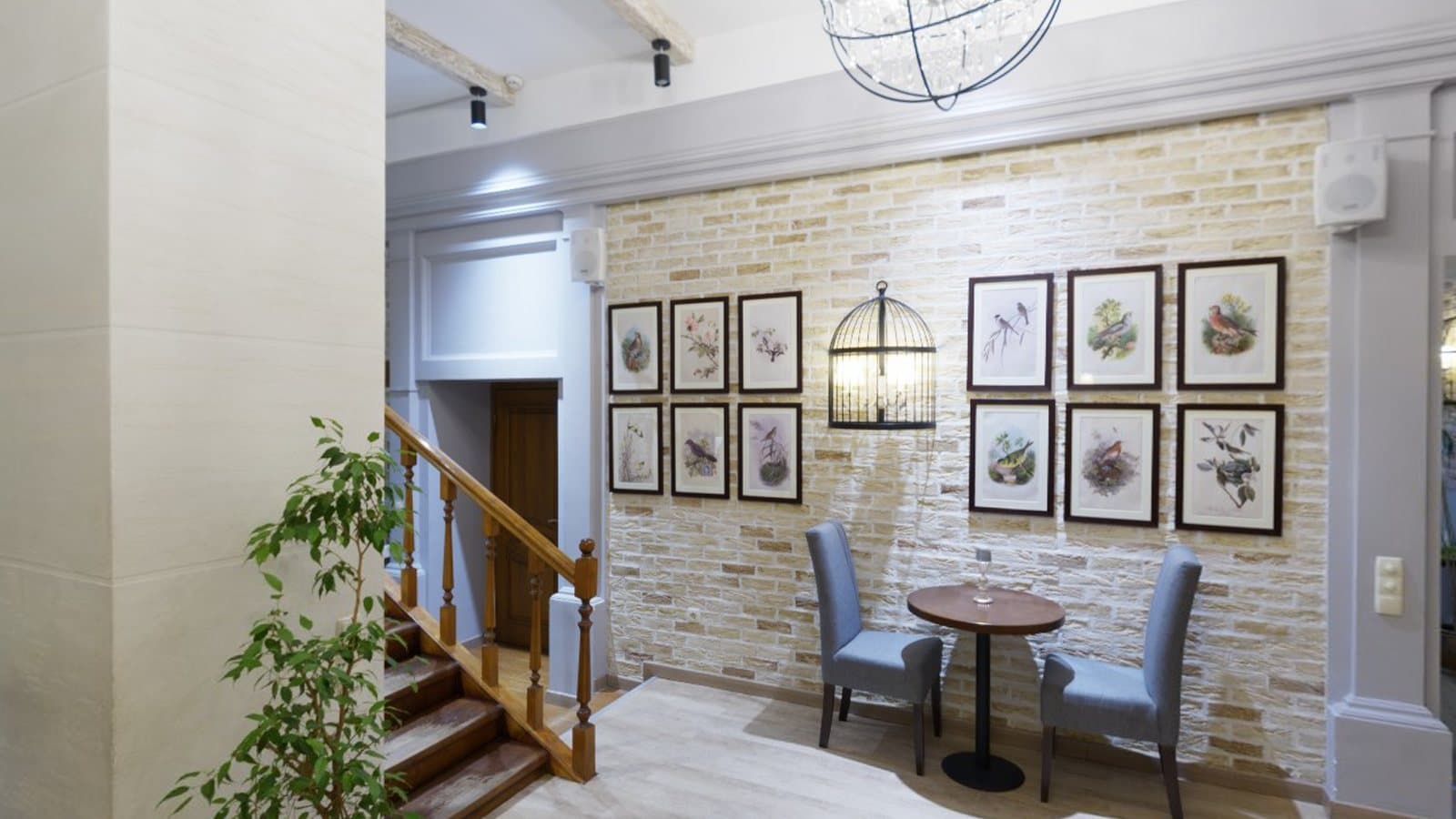 A café interior with brick walls and framed pictures