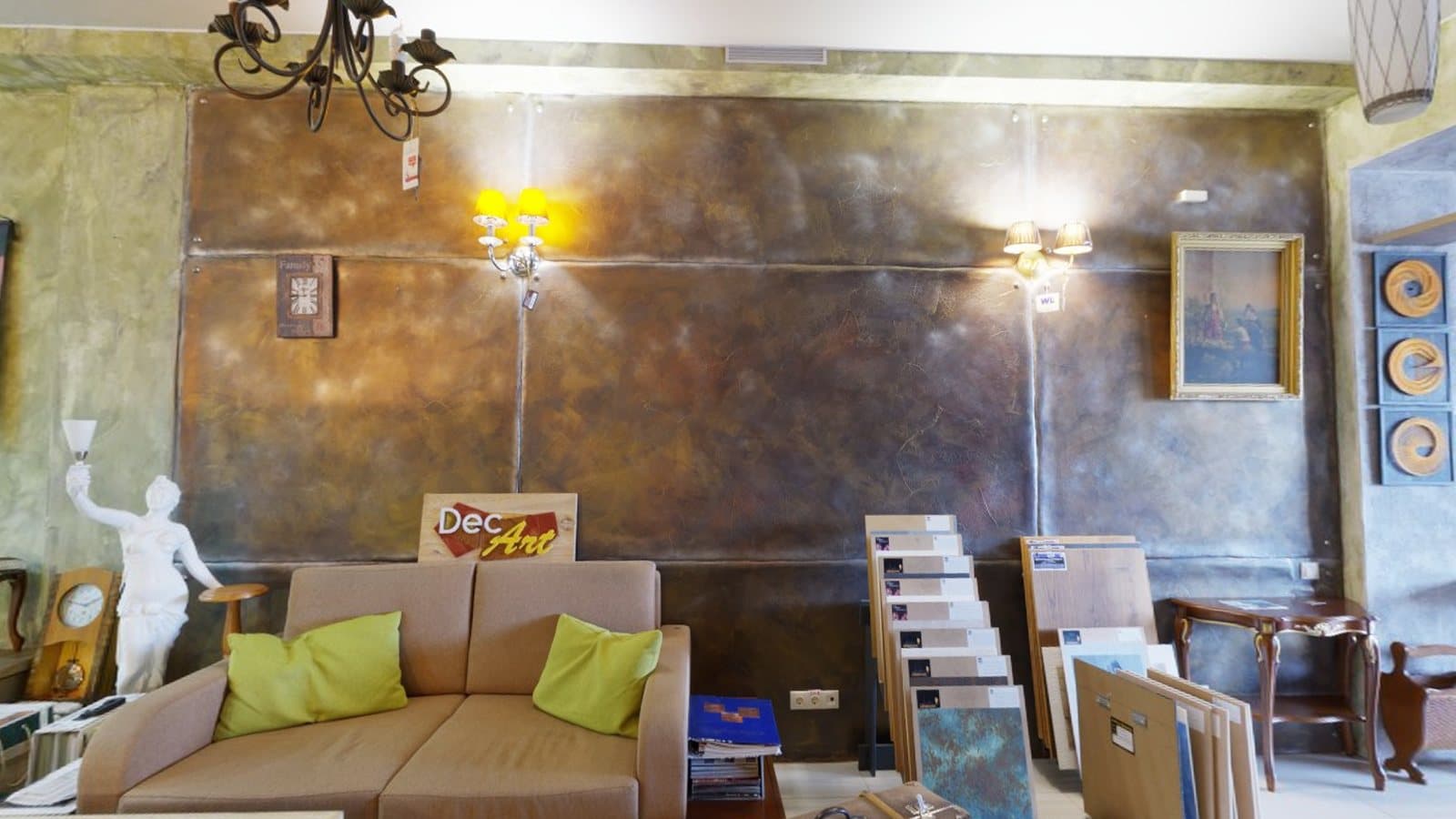 A design showroom with a sofa, sample boards and decorative lighting