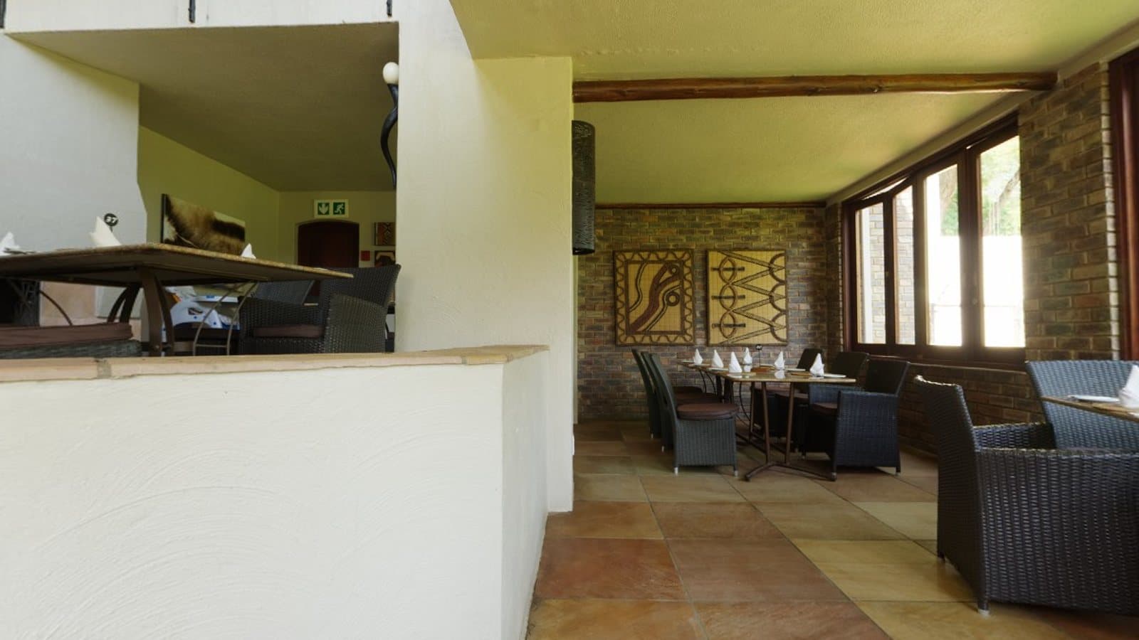 A restaurant interior with tables, chairs and wooden doors