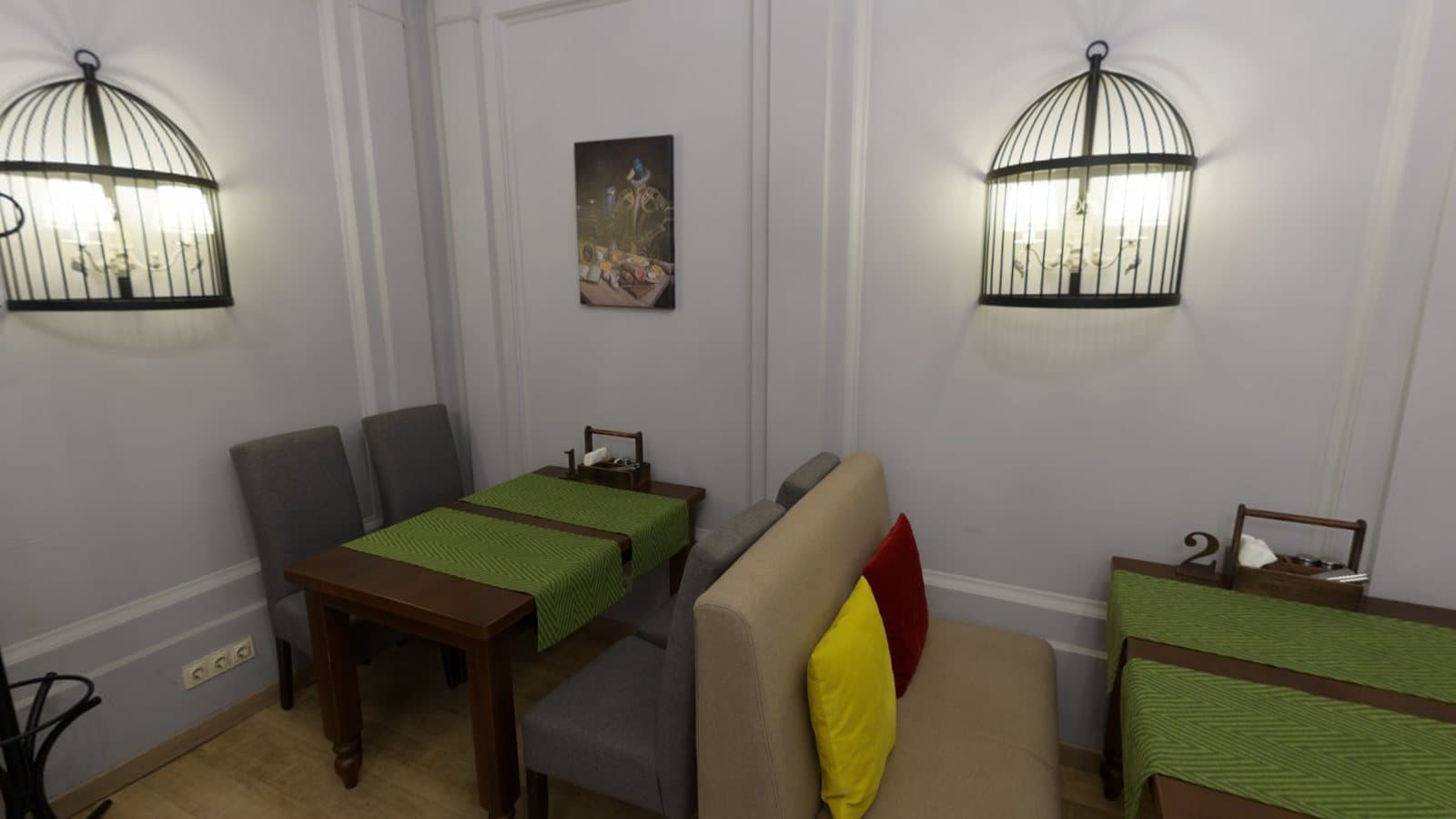 A café interior with brick walls, framed pictures and tables, a scene often photographed as a spherical panorama